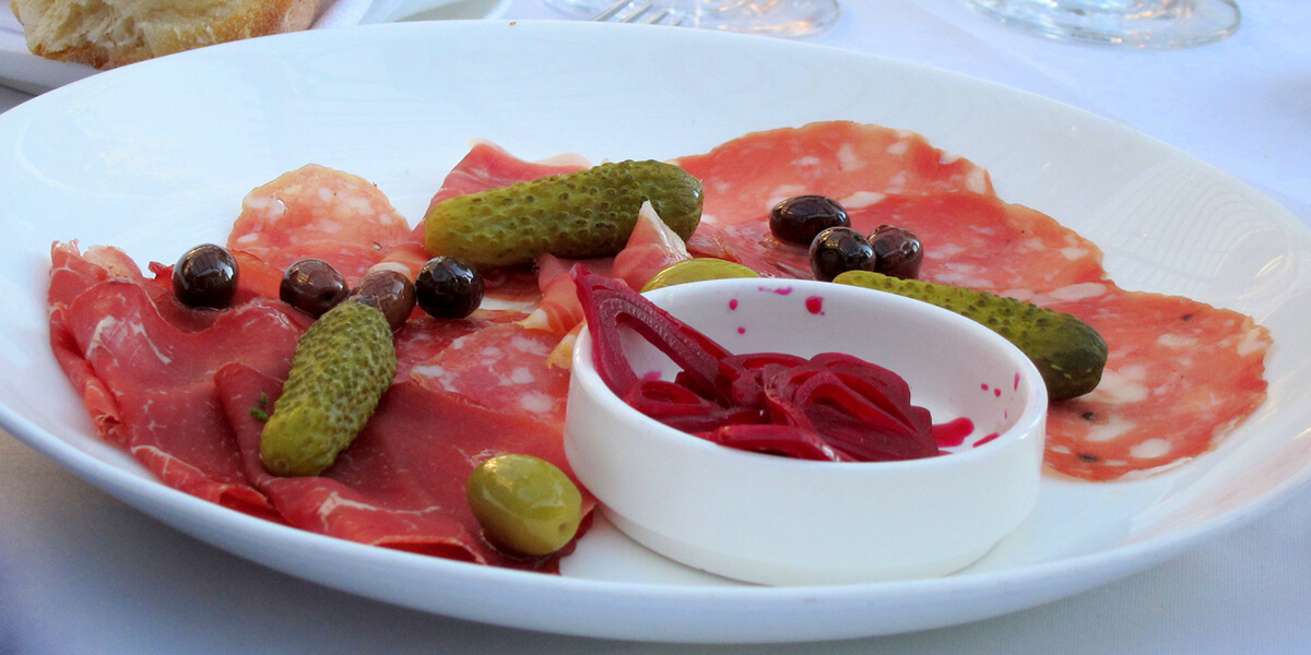 Olives and pickled veggies with cured meat.