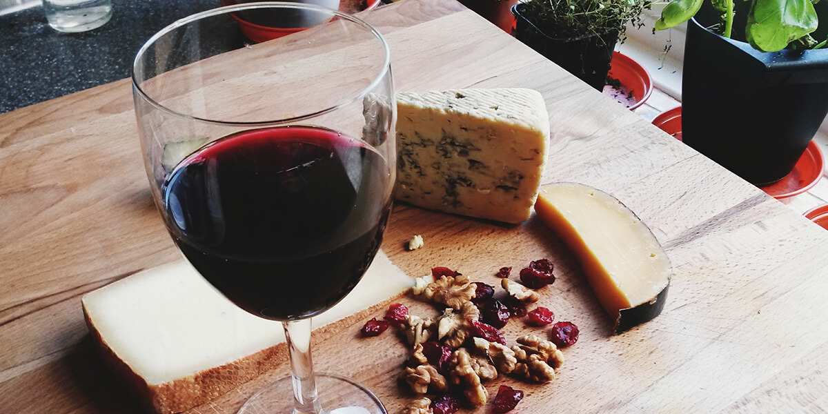 Red wine with cheese and nuts.